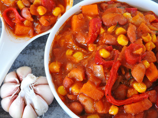 Beans with garlic in Mexican style in a white bowl