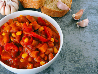 Beans with garlic in Mexican style in a white bowl