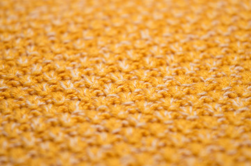 Yellow and white cotton knitted fabric texture, pattern of hand knitted clothing