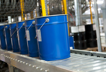 Paint bucket on conveyor. Fragment paint factory