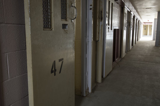 Row of open cell doors in prison