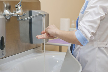 The doctor washes his hands before work
