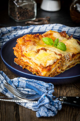 Piece of tasty hot lasagna with red wine.