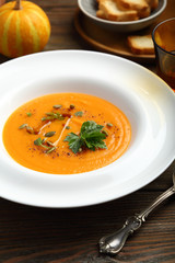 Tasty pumpkin soup in plate