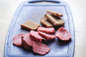 bread with sausage on cutting Board
