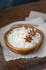 Bowl with white rice on the wooden background, wabi sabi style