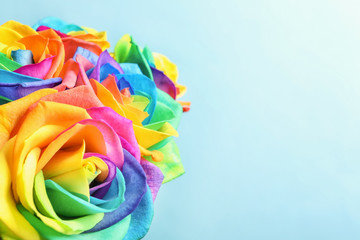 Fototapeta na wymiar Amazing rainbow rose flowers on color background