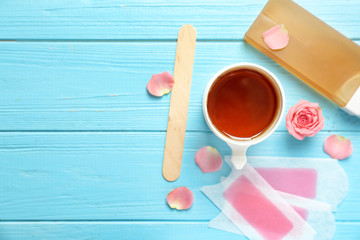 Set for epilation on wooden background, flat lay