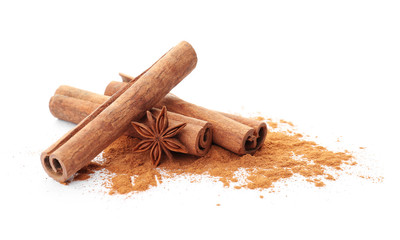 Aromatic cinnamon sticks and powder on white background