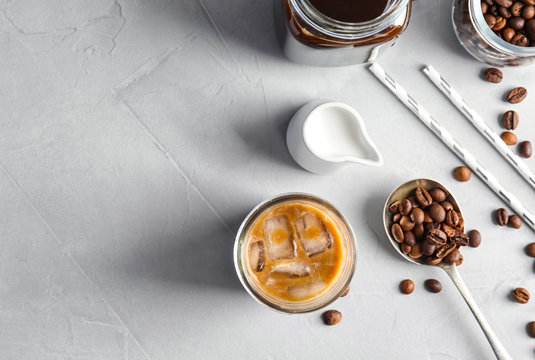 Flat lay composition with cold brew coffee and milk on grey background
