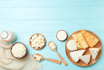 Flat lay composition with different dairy products on wooden background