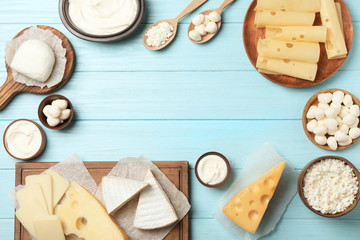 Flat lay composition with different dairy products on wooden background