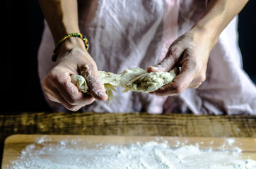 Dough dainted by the woman on the board