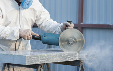 Worker cuts stone grinding machine