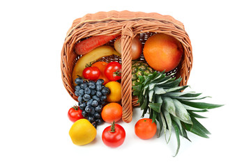 Vegetables and fruits in a basket isolated on white background.