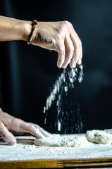 Dough dainted by the woman on the board