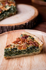 Quiche a savoury open tart  with spinach mushrooms cheese.