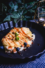 sweet crepe filled with almond and blueberry set on dinner table.