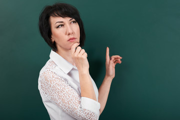 woman posing and thinking on school Board background, learning concept, Studio shot
