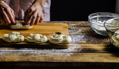 Dough dainted by the woman on the board
