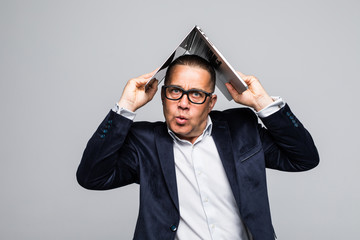 Senior man is covering his head by laptop isolated on white background.