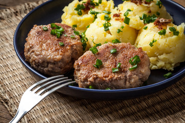 Meatballs served with boiled potatoes.