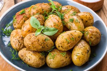baked potatoes, blue plate, close-up, home kitchen, potatoes in the peel