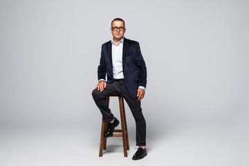 Senior Businessman sitting in chair isolated on white background