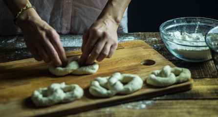 Dough dainted by the woman on the board