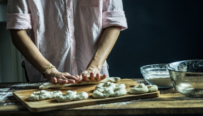 Dough dainted by the woman on the board