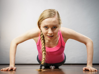 Woman training at home doing push ups