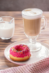 Cup of hot coffee latte beverages with donut glazed
