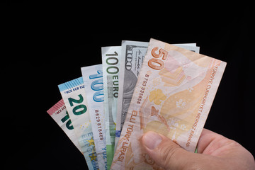 Hand holding American dollar  isolated on black background