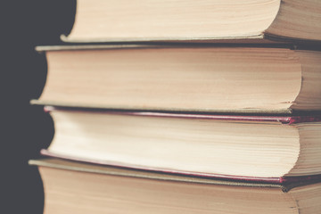 vertical stack of books background toned