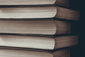 vertical stack of books background toned