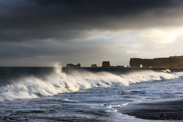 Fototapeta na wymiar Large waves on black beach. Vik, Iceland