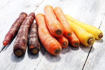 pile of carrots. Crate of mixed fresh harvested colorful carrot.