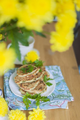 pancakes from vegetables on the table. Yellow flowers. Healthy food. Vegetarian