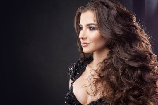 Portrait of a young attractive woman with gorgeous curly hair. Attractive brunette