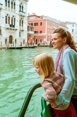 Fototapeta na wymiar Mother and baby girl travel by venice water bus
