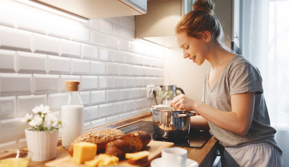 young woman in pajamas prepares breakfast in morning