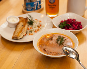 mushroom soup and cod filet surved with vegetable salad