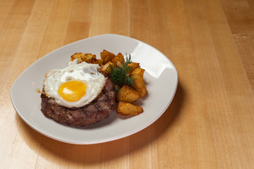  fried meat with egg and potatoes