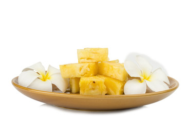 Pineapple piece on dish with flower isolated on white background