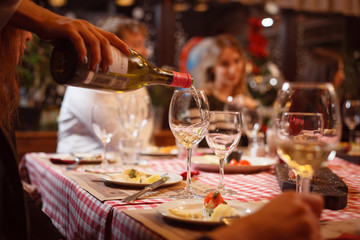 the table is served with glasses for white wine