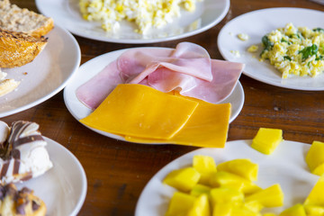 several dishes for brakfast on a wooden table
