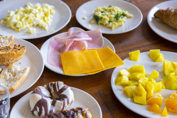 several dishes for brakfast on a wooden table