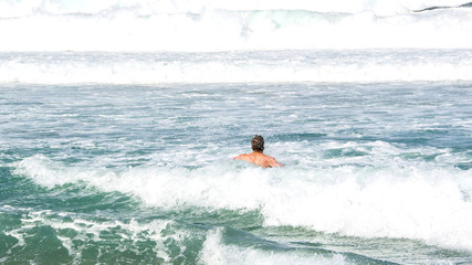 Swimming in the furious waves of Bondi beach in sydney