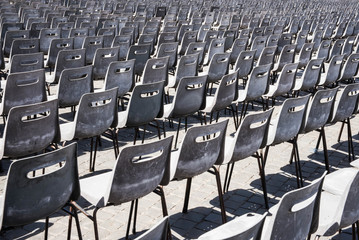 Empty grey seats in large stadium auditorium