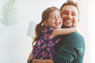 Father's day. Happy family daughter hugs his dad